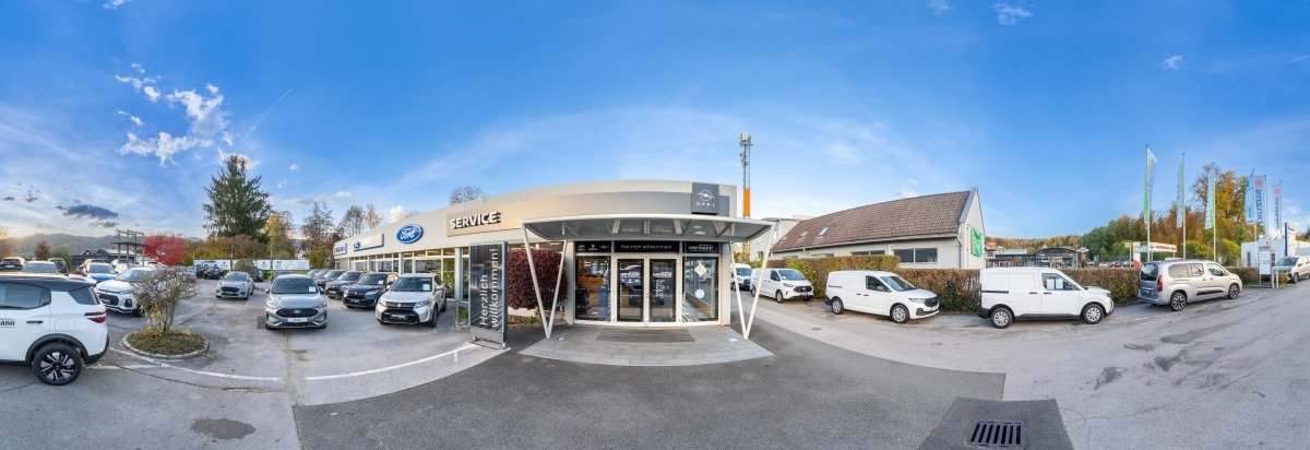 Panorama eines Autohandels mit mehreren Fahrzeugen, dem Ford-Schild und dem Servicebereich.